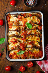 Eggplant Casserole, Roasted Eggplant Dish with Minced Meat, Tomato Sauce and Mozzarella over Rustic Background