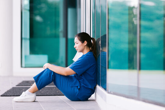 Exhausted tired doctor or nurse.Clinic and hospital medical stuff working over hours. Overworked professional. Stress and depression.
