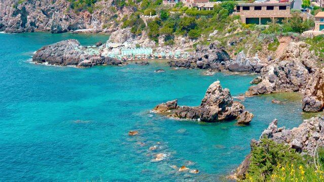 Talamone rocky beach and medieval fortress Rocca Aldobrandesca and walls. The village lies on a rocky promontory, in Maremma nature reserve, mount Argentario, Tuscany, Italy