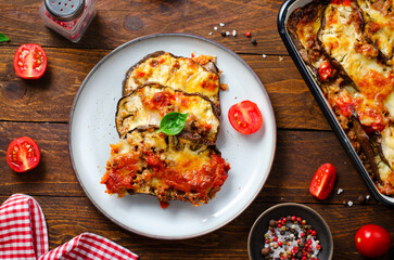 Eggplant Casserole, Roasted Eggplant Dish with Minced Meat, Tomato Sauce and Mozzarella over Rustic Background