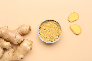 Fresh ginger root and bowl with dried powder on orange background