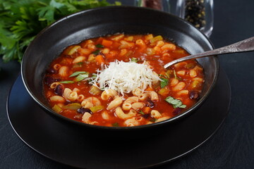 A bowl of minestrone soup with mix of vegetables. Italian cuisine - obrazy, fototapety, plakaty
