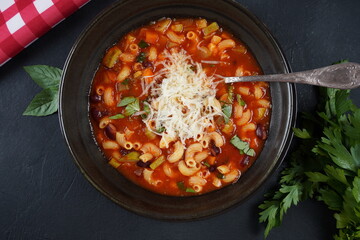 A bowl of minestrone soup with mix of vegetables. Italian cuisine