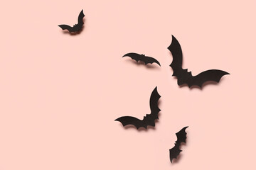 Obraz na płótnie Canvas Paper bats for Halloween party on pink background