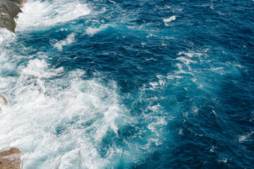 Fototapeta na wymiar Waves on the sea. View from above on Ligurian Sea in Portofino