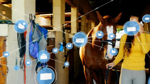 Animation of connected icons over caucasian woman holding horse and talking on cellphone at stable
