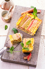 Traditional German rhubarb pie with vegetable served as close-up on a stone design tray