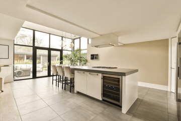 a kitchen and dining area in a house with large glass doors that open to the patio, which has been used for several years