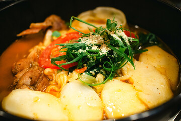 close up of hot pot chicken soup topped with vegetables and potatoes
