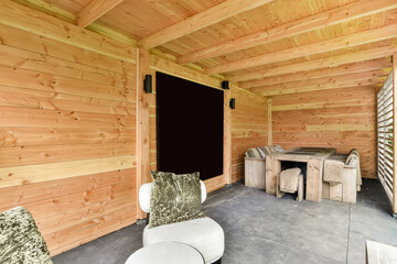 a living room with wood paneled walls and white furniture on the floor, in front of a blackboard wall