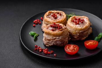 Delicious baked meat roll wrapped in bacon with salt, spices and herbs