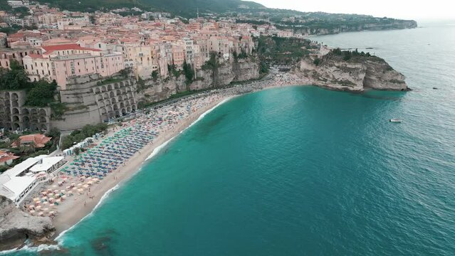 aerial view from the drone of the beautiful village of Tropea in Calabria, a Unesco heritage site. You can see the Caribbean sea, the port, and the sanctuary of Santa Maria. 