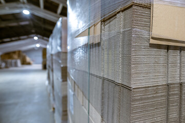Folding cardboard boxes. Perforated sheets of corrugated cardboard a stack on pallets. Packaging of finished products in industrial production. - 628831133