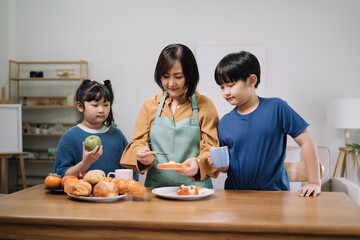 Mother serves them breakfast. Everyone is happy and smiling, parents enjoy spending time with their children.