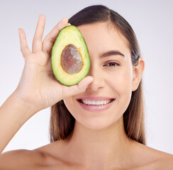 Face, skincare and woman smile with avocado for beauty cosmetics isolated on a white background in studio. Portrait, happy and natural model with fruit food for nutrition, healthy diet or wellness