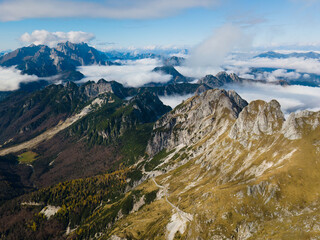 Rocky mountains rising above clouds. Photo taken with a drone. Julian Alps, Slovenia.