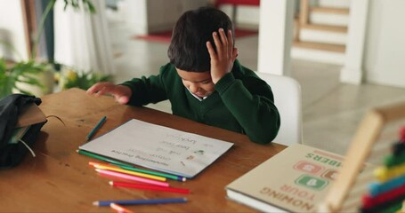 Boy, writing and education with mistake, home and stress with book, pencil or learning language at desk. Male child, student and paper with fail in assessment, test and study at table in family house