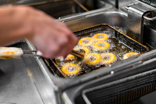 woman chef hand cooking Deep fried onion ring on kitchen