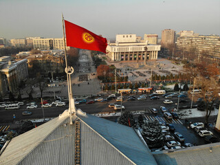 Kyrgyzstan flag near theatre in Bishkek at winter time. High quality photo