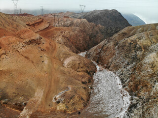 high voltage line mountains at winter. Konorchek Canyons Kyrgystan. Aerial drone view. Flying over.. High quality photo