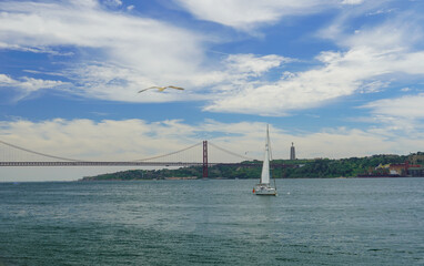 Tagus river Lisboa. 25 de Abril Bridge and Christ the King monument in Portugal. High quality photo