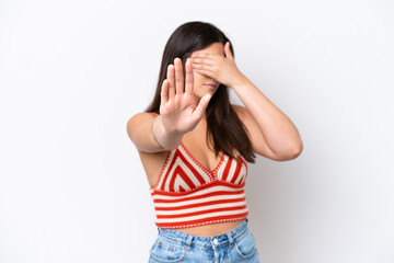 Young Brazilian woman isolated on white background making stop gesture and covering face