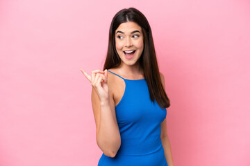 Young Brazilian woman isolated on pink background intending to realizes the solution while lifting a finger up