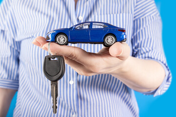 agent manager holding a car and car key in hand, car loan, credit for vehicle