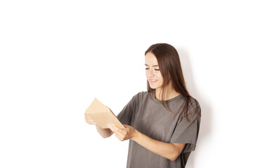 Fototapeta premium student opens college acceptance letter,teenager receives message in envelope,woman with postal documents on white background, invoice, bills, mail delivery