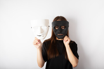 actor with black and white mask trying on roles, young woman making a choice between good and evil