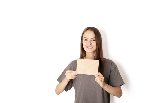 young woman with an envelope on a white background, delivery of documents by mail, delivery of letters by courier, postal services