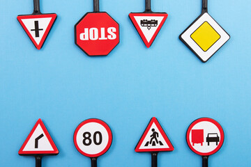 driver's license exam preparation, road safety and security, road signs on a blue background, copy space