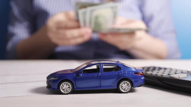 car insurance, vehicle financial protection, woman counting money compensation for damages for theft in the office