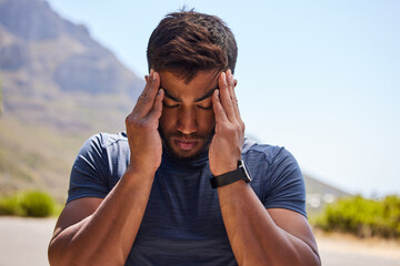 Stress, runner or man with headache in on road after workout, exercise or running training outdoors. Fitness emergency, sports athlete or stressed person with migraine, head pain injury or burnout