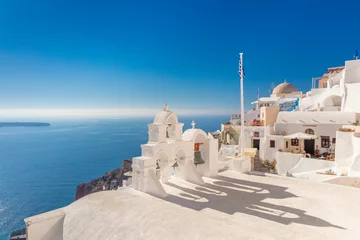 Foto op Canvas Famous Santorini, Oia, Greece. Minimalistic composition traditional architecture of Santorini island. White arches with domes against the background of the blue sea © Taiga