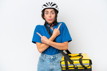 Young caucasian woman with thermal backpack isolated on white background pointing to the laterals having doubts