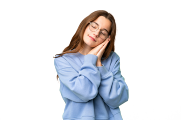Teenager girl over isolated chroma key background making sleep gesture in dorable expression
