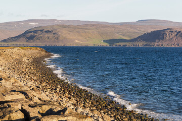 look through the scenic coastline of Patreksfjörður at sunset