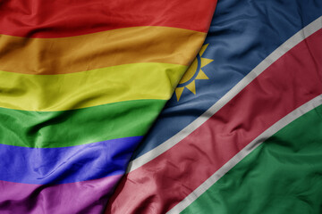 big waving realistic national colorful flag of namibia and rainbow gay pride flag .