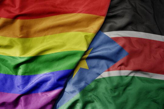 big waving realistic national colorful flag of south sudan and rainbow gay pride flag .