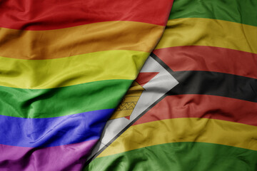 big waving realistic national colorful flag of zimbabwe and rainbow gay pride flag .