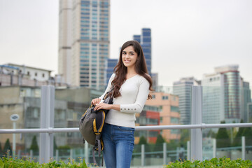 Fototapeta premium In Korea, a white woman is standing with a bag on.