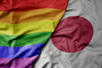 big waving realistic national colorful flag of japan and rainbow gay pride flag .