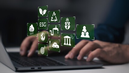 ESG environment social governance investment business concept. ESG icons pop up on the computer...