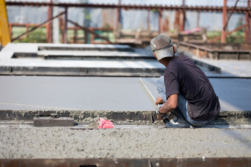 Asian man worker pouring concrete slab. Asian Engineer man working at precast factory. Engineering...