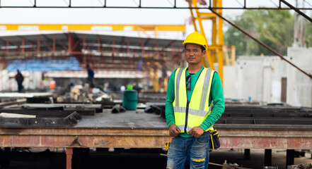 Portrait Asian professional Engineer factory. Engineering worker in safety hardhat at factory industrial facilities. Heavy Industry Manufacturing Factory. Prefabricated concrete walls