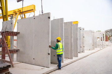 Reinforced concrete structures. Man construction worker control large crane for placing precast...