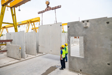 Reinforced concrete structures. Man construction worker control large crane for placing precast...