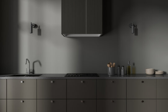 Dark hotel modern kitchen interior with sink and kitchenware