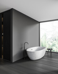 Grey bathroom interior with bathtub, stool and window. Mockup wall